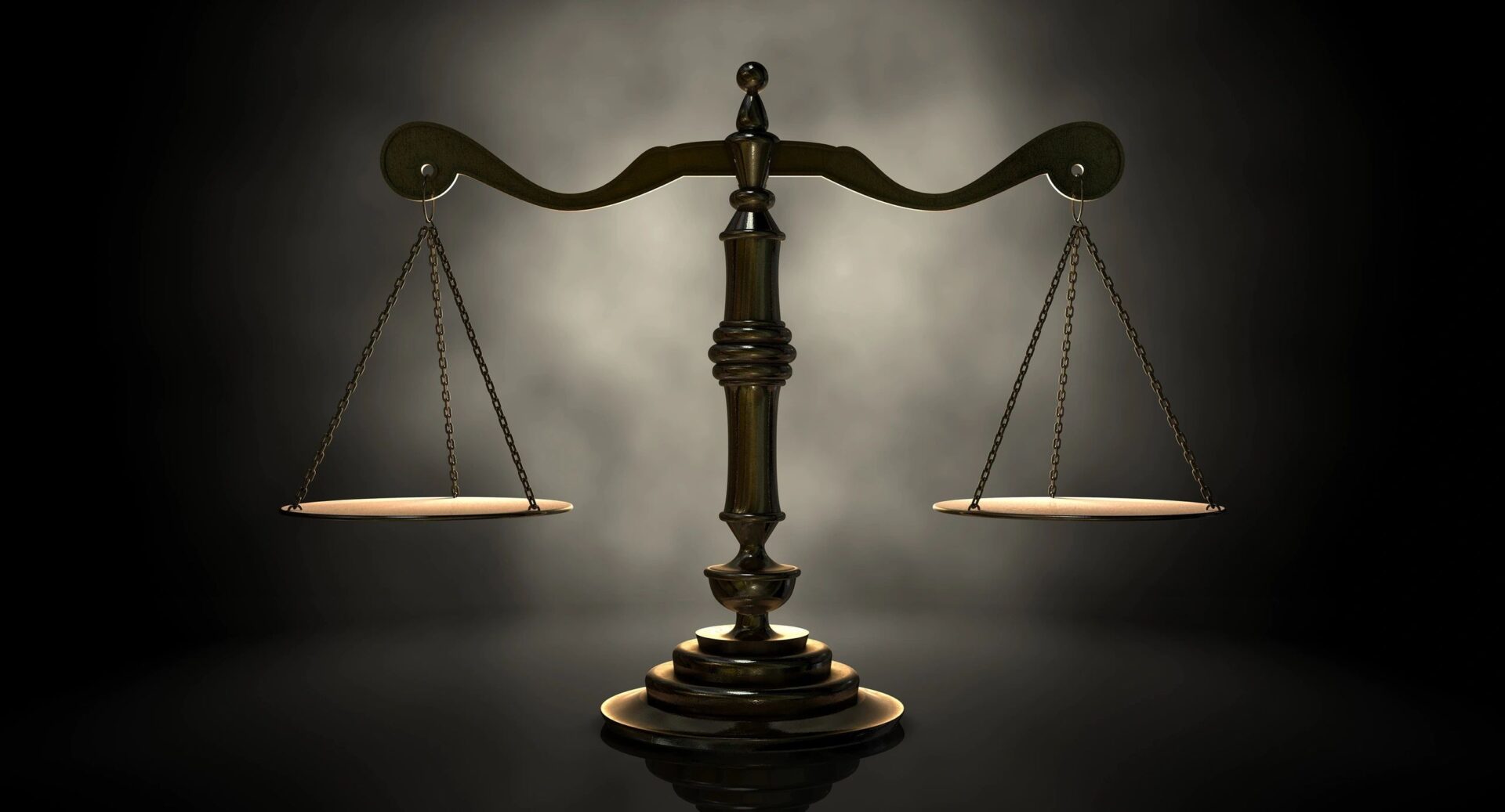 A close up of the scales of justice on a table