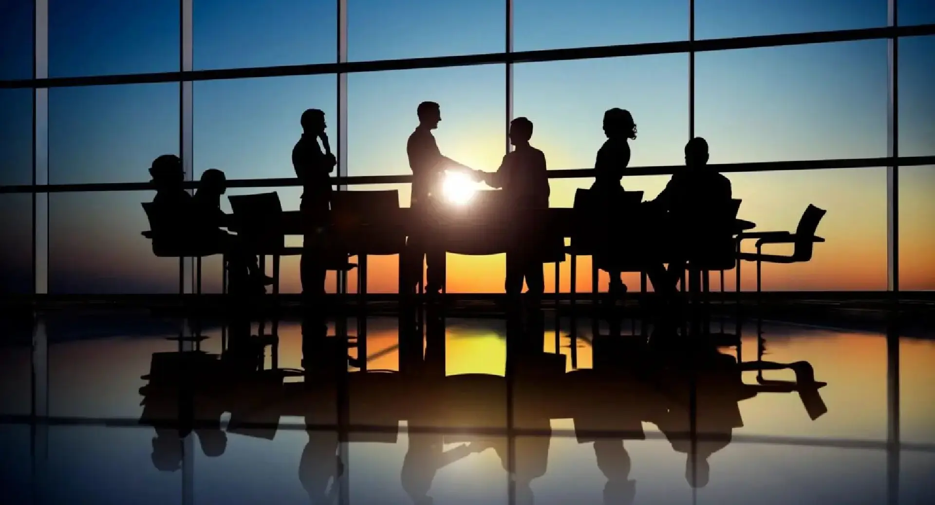 A group of people standing around a table.